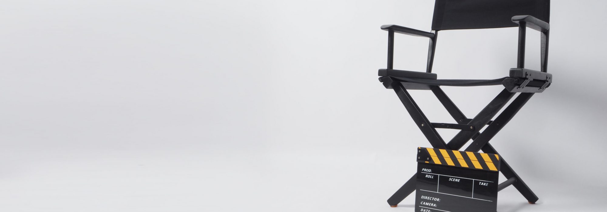 Director chair with black and yellow clapper board or movie slate on white background.it is used in video production and film industry.